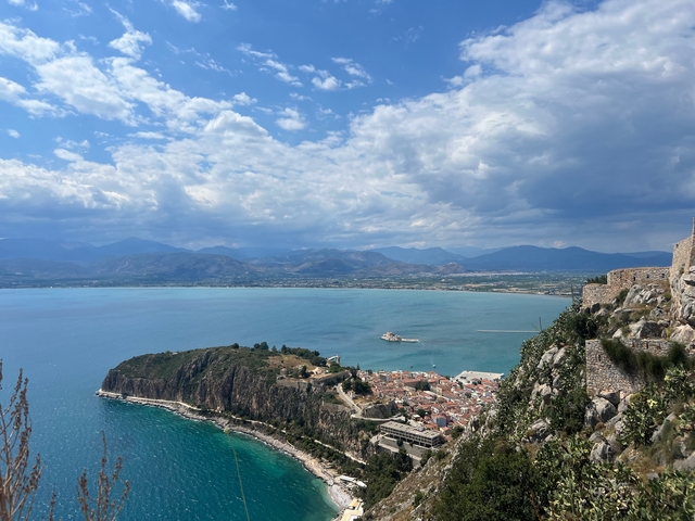 Distant view of a coastal town and surrounding hills.