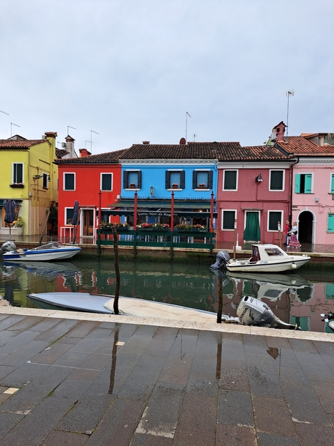 Colorful buildings by a canal with boats