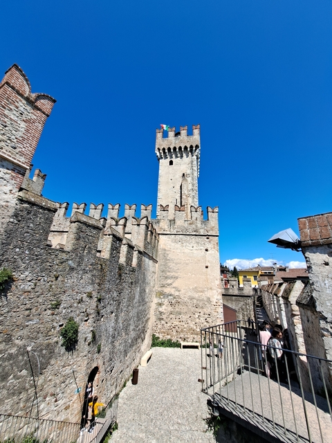 Historic tower and walls under a clear blue sky