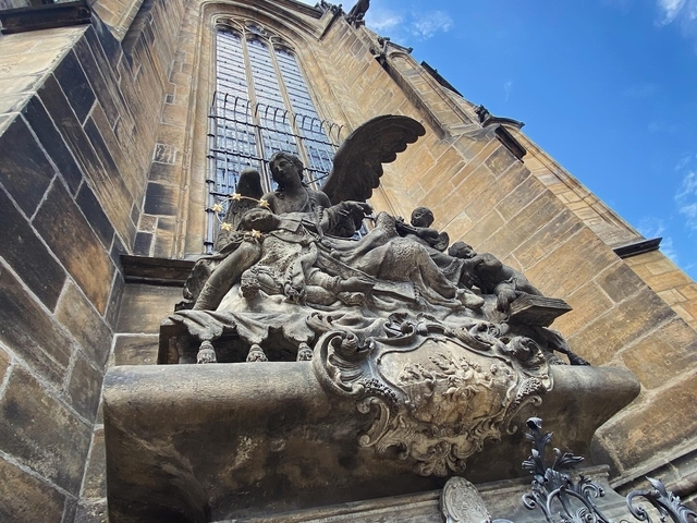Intricate sculpture on the side of a historic building.