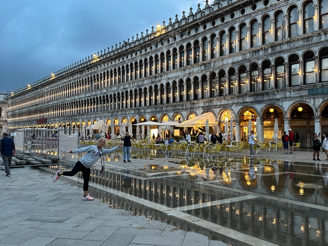       St. Mark's Square with reflections on the water in Venice.
  
