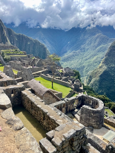 View of Machu Picchu ruins nestled in a mountainous landscape.