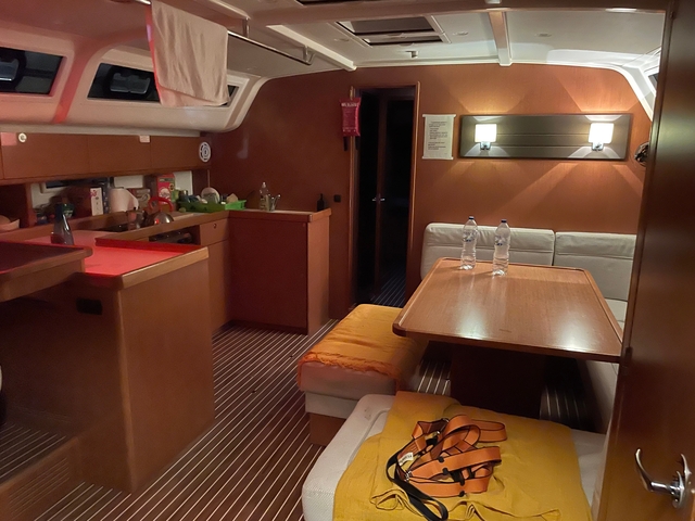       Interior view of a yacht's cabin with dining area.
  