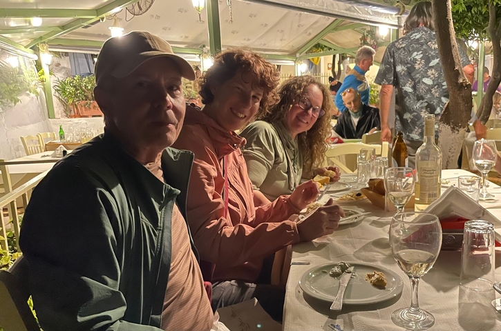       People dining at a restaurant with cozy ambiance.
  