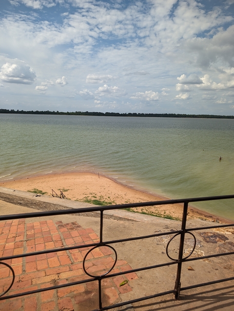 A sandy beach with calm waters.
