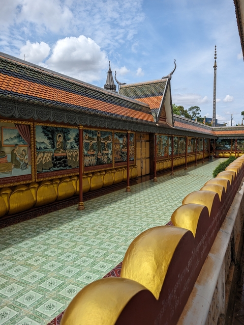 Colorful murals on the exterior wall of a temple.