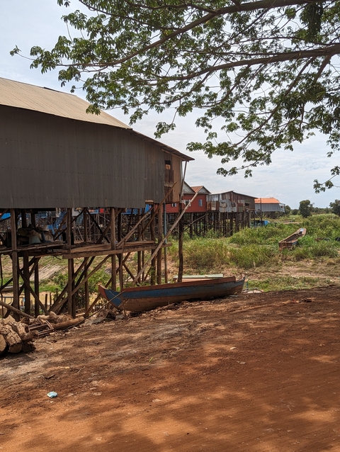 Houses on stilts near a riverbank.