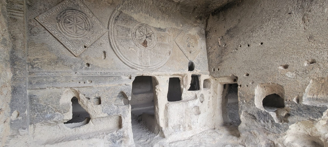 Stone carvings in an ancient cave structure.