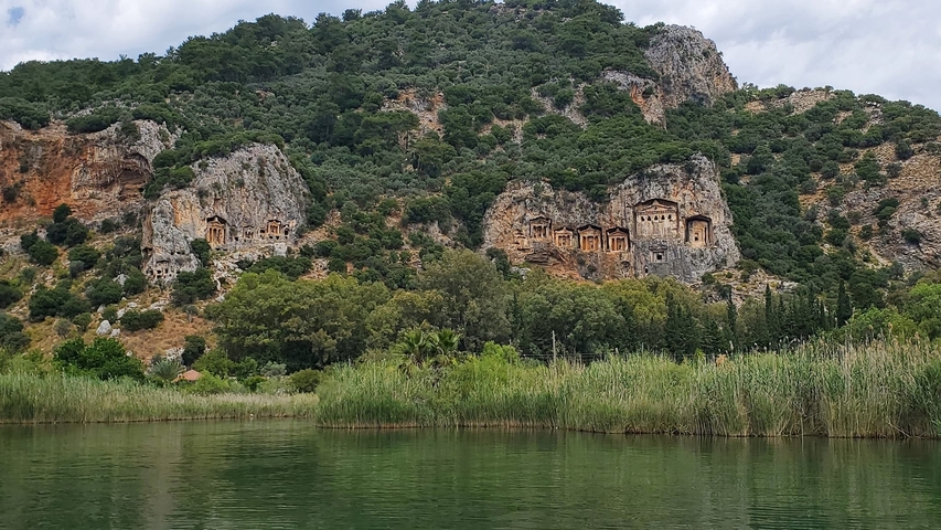 Rock-cut tombs in a cliffside view.