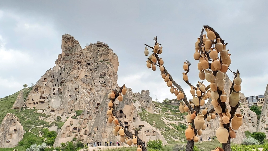       Rock formations and pottery display in a unique landscape.
  
