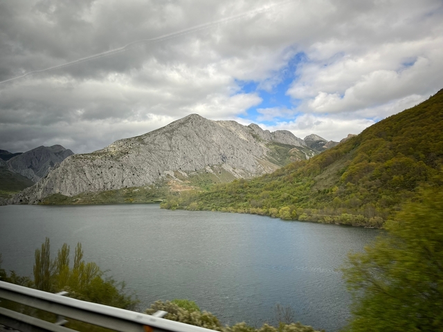       Mountain range with a lake and lush greenery.
  