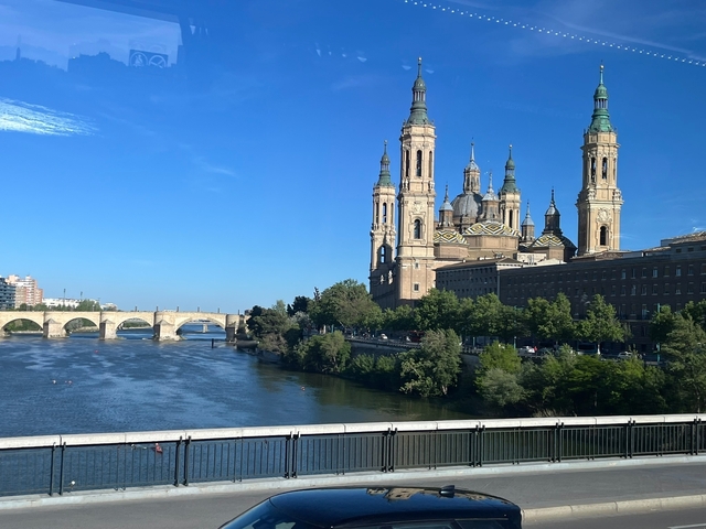       Large cathedral with a river and bridge in the foreground.
  