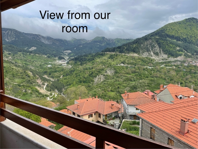       Houses with mountains and a sign saying 'room'.
  