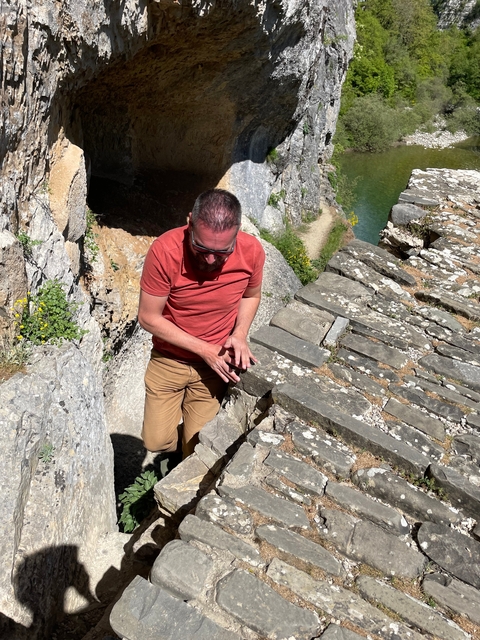       Man walking on stone steps.
  