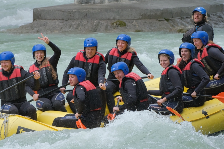 Group of people white-water rafting.