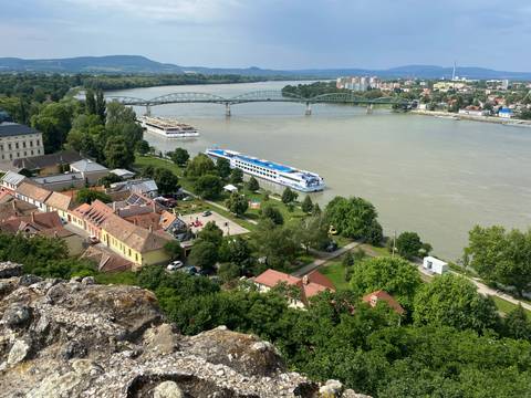 View of a river with a bridge and boats.