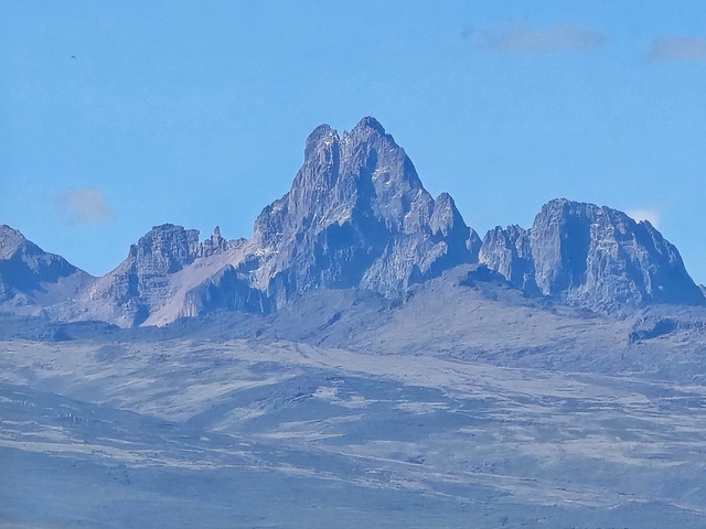       Mountain range under clear skies.
  