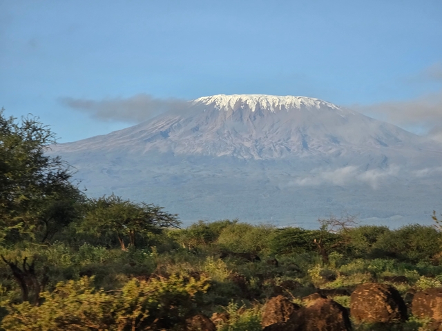       Mount Kilimanjaro peeking through clouds.
  