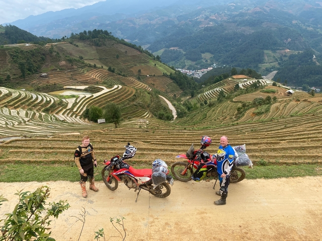 Motorcyclists overlooking terraced rice fields