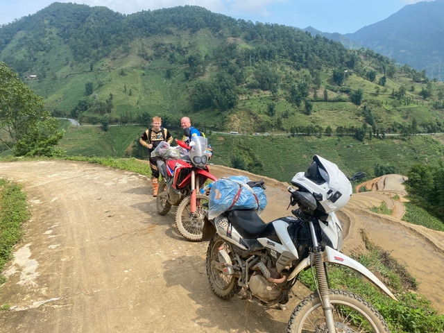 Motorcyclists posed on a scenic mountain road
