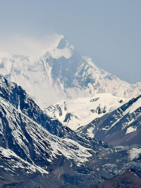       Snow-covered mountain range against the sky
  