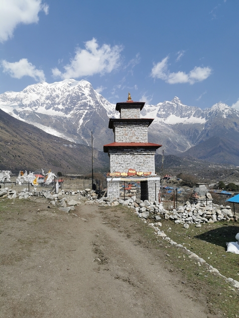       Stupa with mountains in the background
  