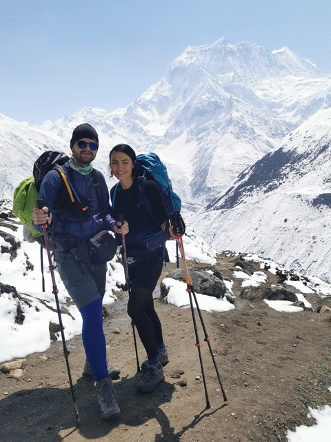       Two hikers posing on a snowy trail
  