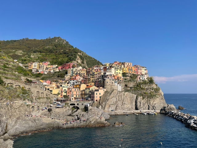 Colorful cliffside village overlooking a rocky shore
