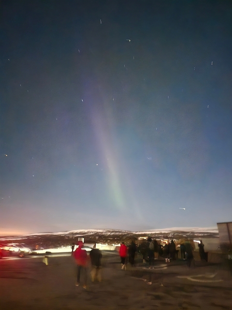 Faint aurora borealis visible against a clear night sky.