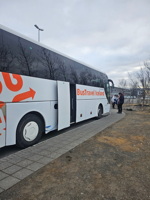 Tourists boarding a travel bus in Iceland.