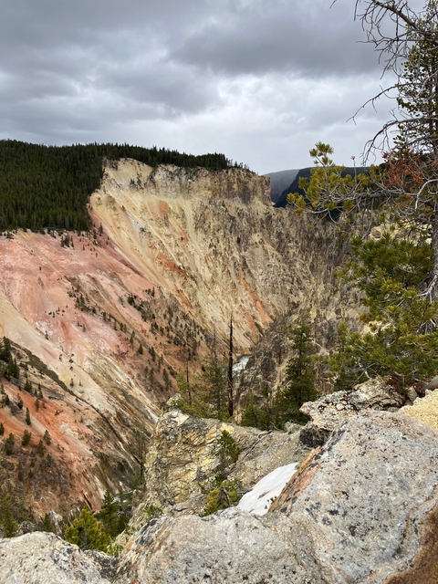       Colorful rock formations in a canyon setting.
  