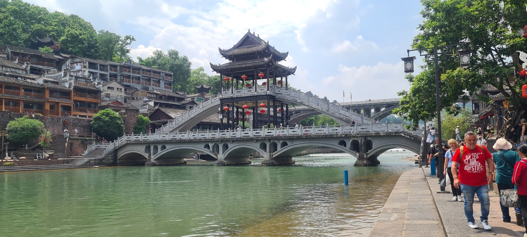 Traditional architecture on a bridge over a river in Fenghuang.