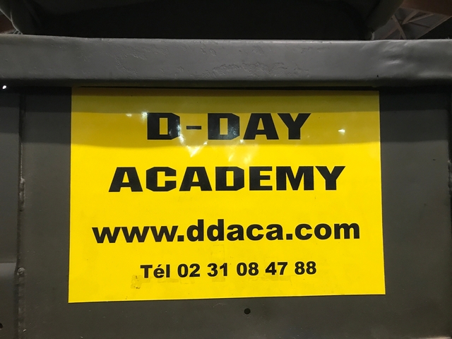 D-Day Academy sign with website information.