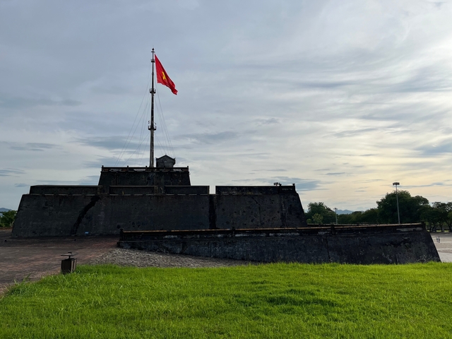 Strong fort with Vietnamese flag on a pole.