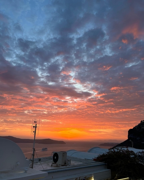 Vivid sunset sky with orange and pink hues.