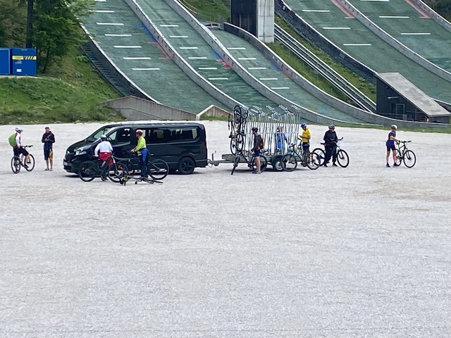 Cyclists preparing for a ride on a mountain bike park.