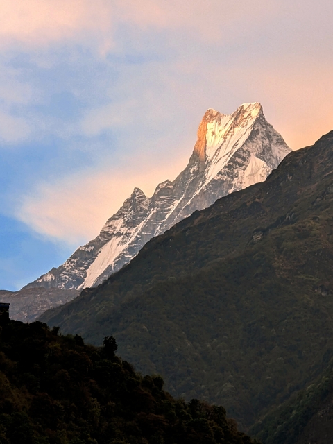      Snowy mountain peaks at sunrise.
  