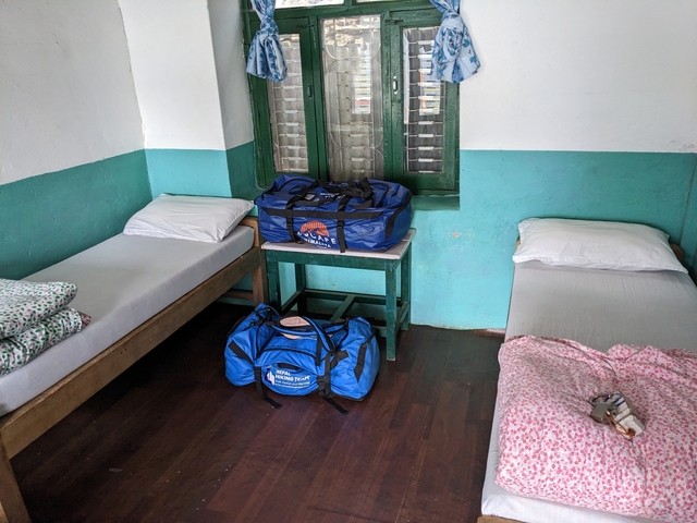       Simple accommodation with backpacks on beds.
  
