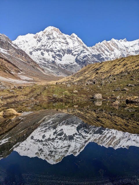       Mountain landscape reflected in a clear lake.
  