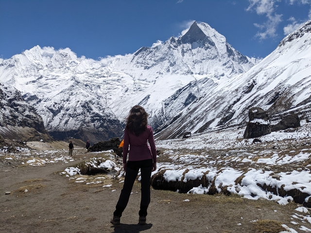       Person gazing at mountain peaks covered in snow.
  