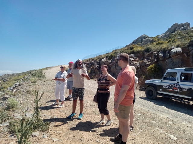       Group of tourists taking a break on a mountain road.
  