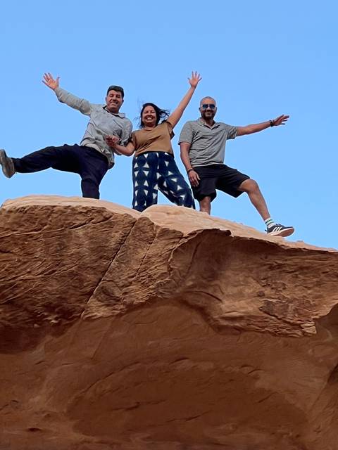       Close-up of people standing on a rock.
  