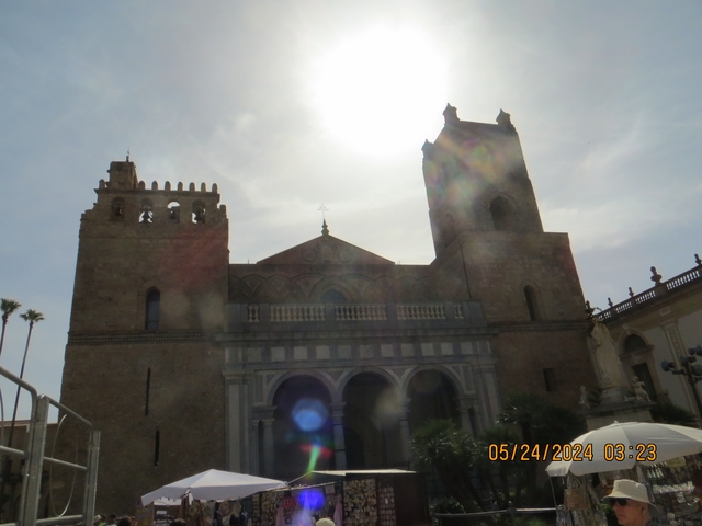       The facade of Monreale Cathedral under a brooding sky.
  