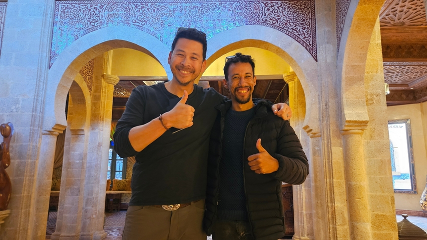 Two people smiling and posing indoors.