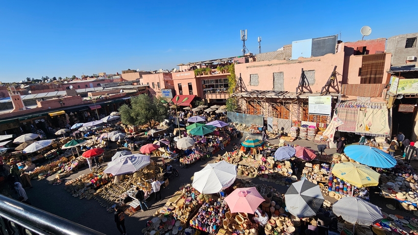 Colorful market scene with many umbrellas and stalls.