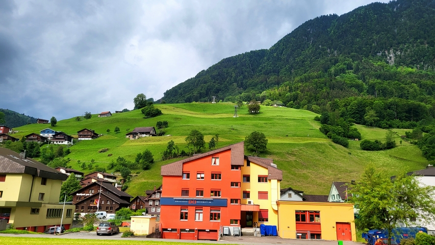 Village with colorful houses against a mountainous landscape.