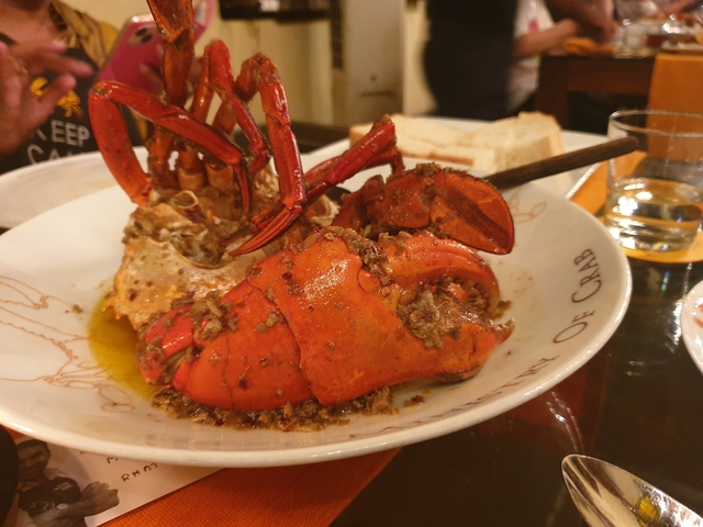 Cooked crab dish served with sauce in a plate.