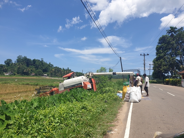       Workers using a tractor for farming in a rural area.
  