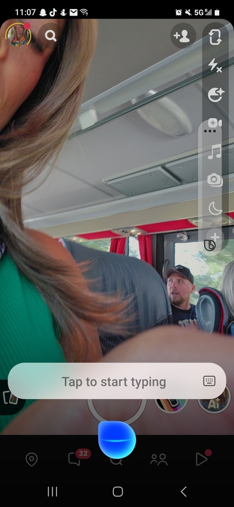 A blurry interior of a bus with people seated inside.