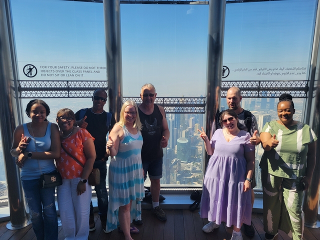 People posing for a photo on an observation deck.